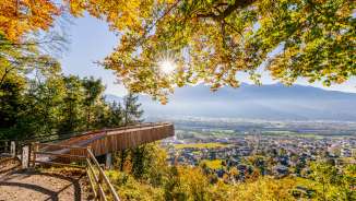 Viewing platform bathed in golden autumn light, offering views of Vaduz and the surrounding countryside