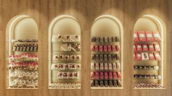 Decorative wall shelf featuring stylishly arranged boxes of chocolates and fine treats