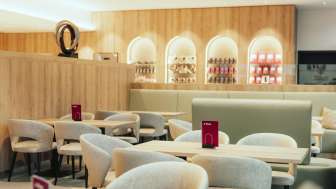A modern café featuring light wood accents, stylish seating areas, and a welcoming atmosphere