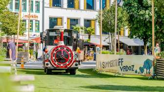 Citytrain drives through Vaduz on green artificial turf at the Summer Gathering in Vaduz