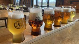 A variety of beers in a tasting set on a wooden table—ranging from light to dark beers, served in stylish glasses at the Liechtenstein Braustube